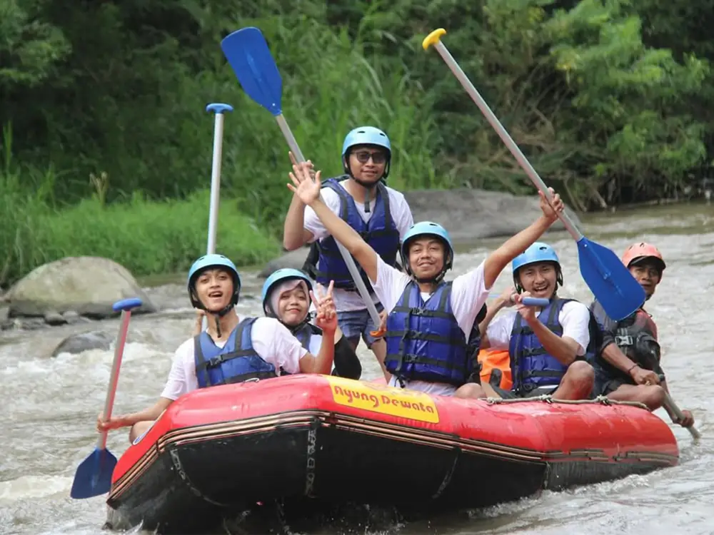 A rafting crew in helmets and buoyancy jackets on the Ayung River, Bali