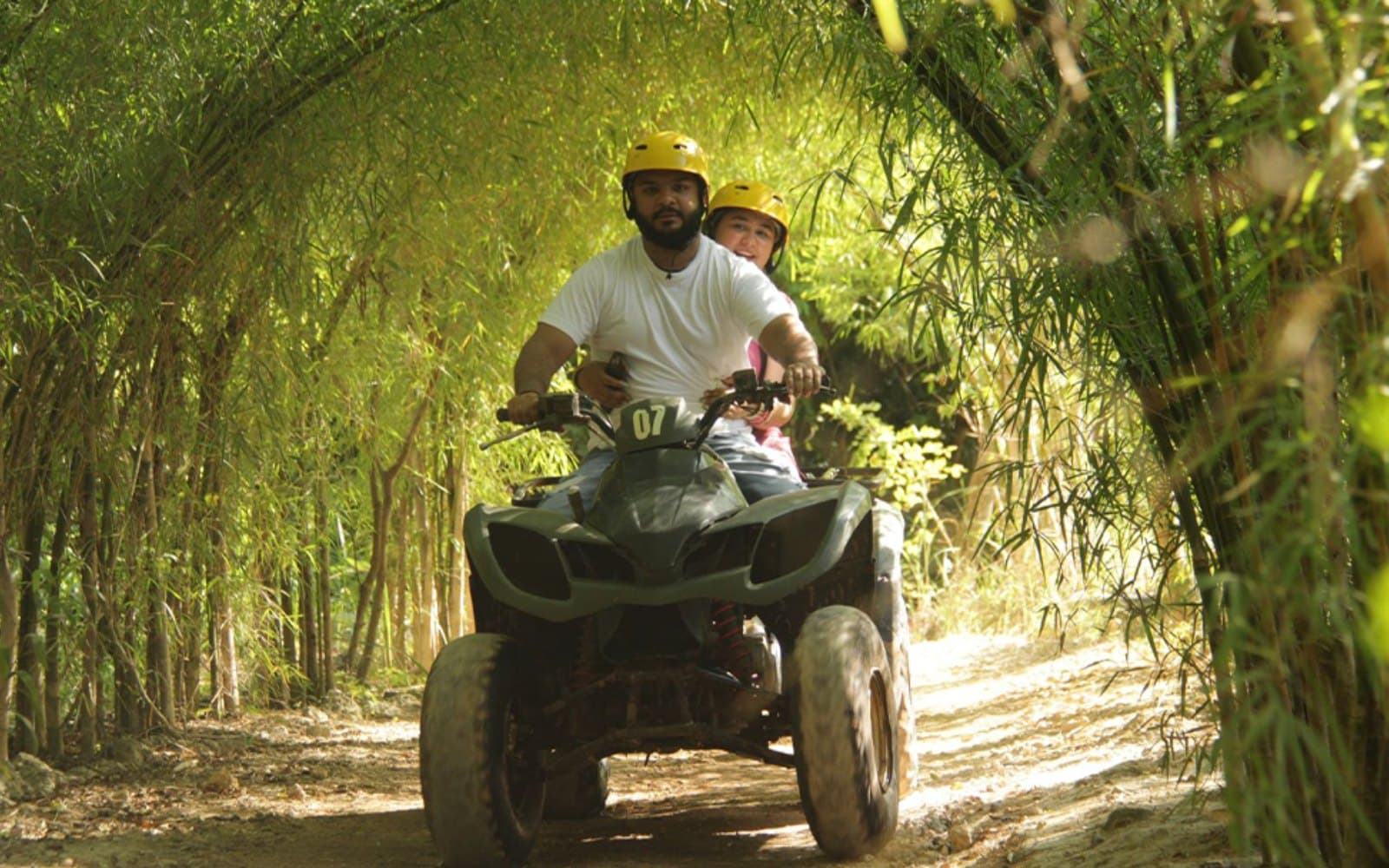 Action-packed riding through scenic dirt paths and lush greenery, perfect for thrill-seekers looking for an unforgettable outdoor adventure.